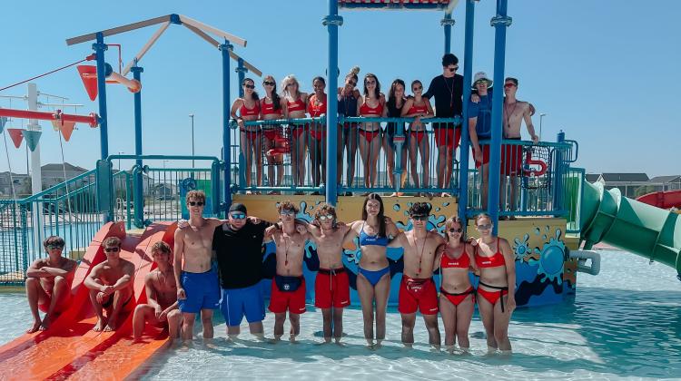 Davies2.jpg Lifeguards at the Davies Outdoor Pool standing on the aquatic playground lined up for a picture.