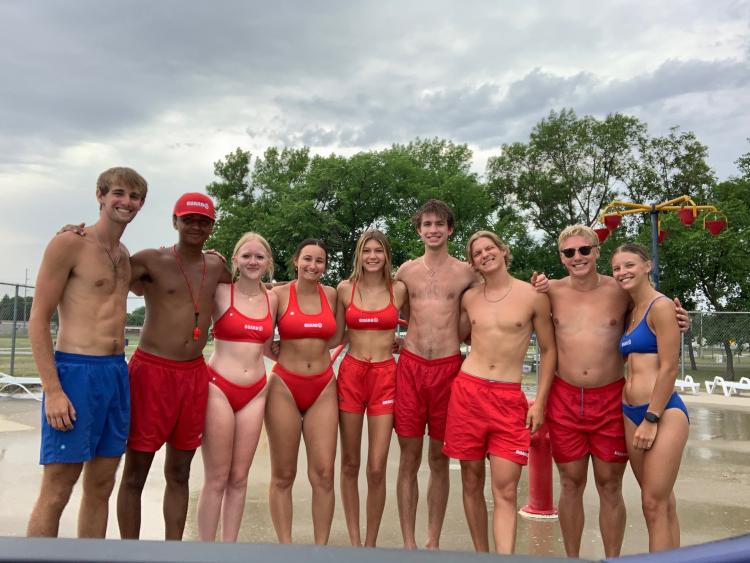 Madison.jpg 9 lifeguards at the Madison Outdoor Pool standing together lined up for a picture.