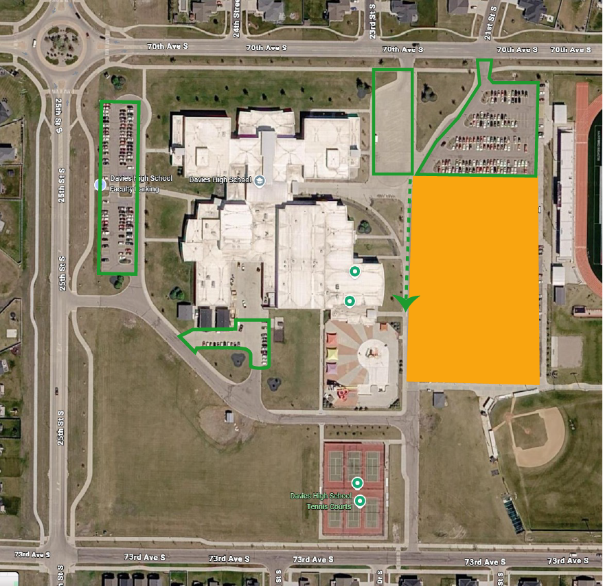 Aerial map of Davies High School showing a designated construction detour route. Green arrows direct traffic south on 25th Street South, east on 73rd Avenue South, and north into the southeast entrance near the student parking lot. A red line marks a closure or restricted access point along 70th Avenue South near the northeast side of campus. The school building, parking lots, tennis courts, and surrounding streets are labeled.