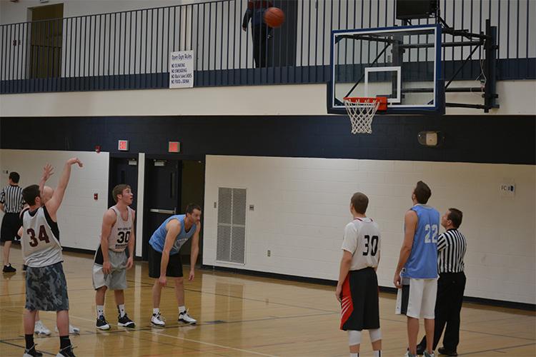 This image shows a male shooting free throws at the adult basketball program.
