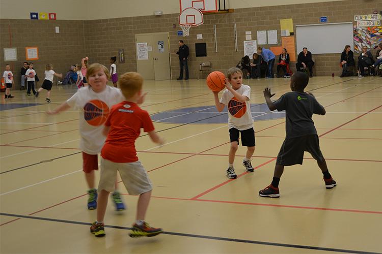 This image shows young children on the court at the youth basketball program.