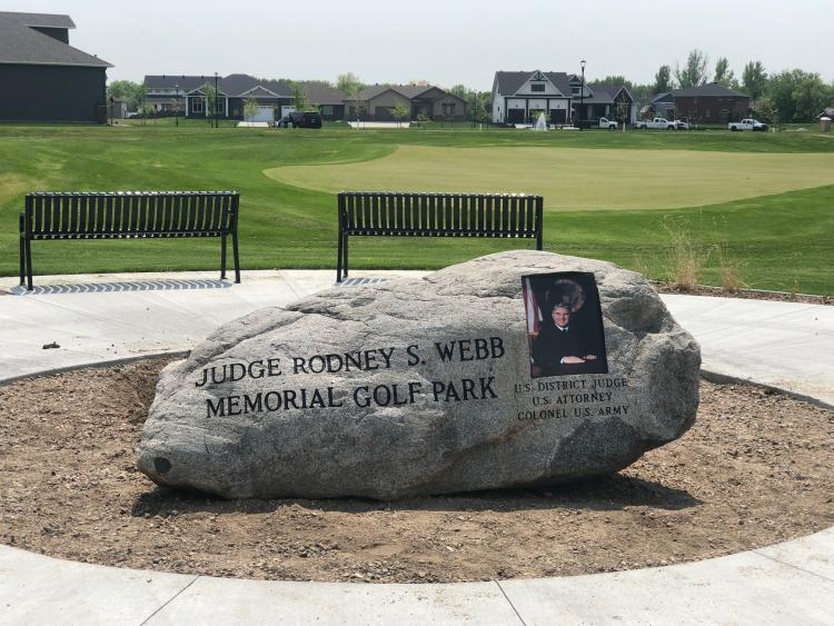 This image shows the memorial rock at the Judge Rodney Webb Memorial Golf Park.