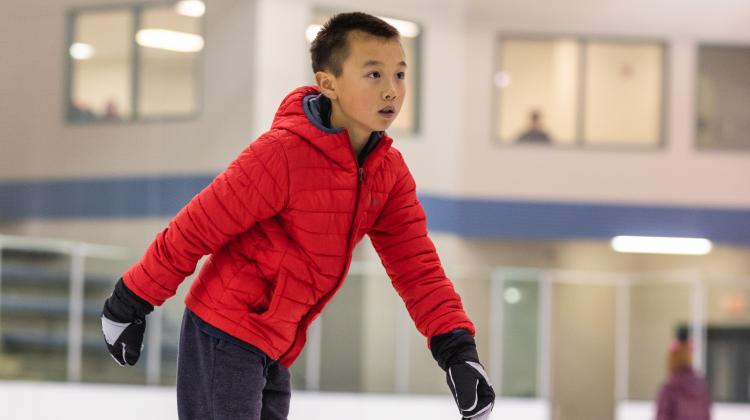 This image shows a boy ice skating.