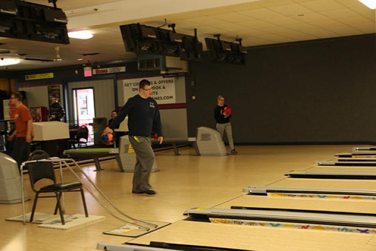 This image shows some people bowling with the adaptive bowling program.