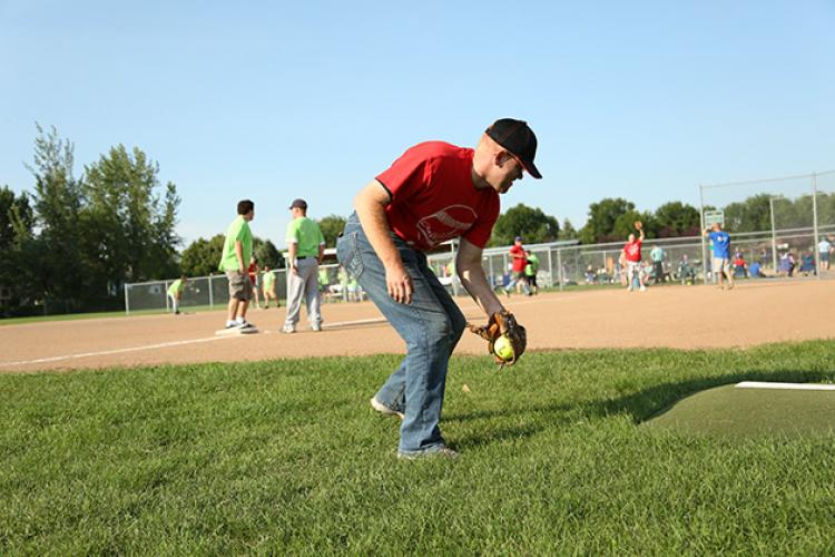 This image shows a male fielding the ball during the adaptive softball program.