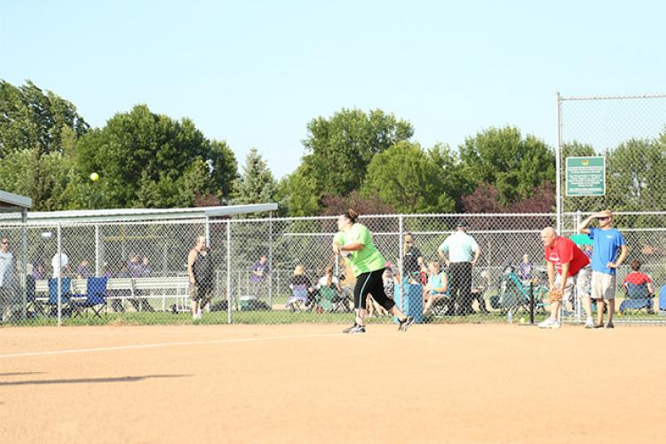 This image shows a female batting during the adaptive softball program.