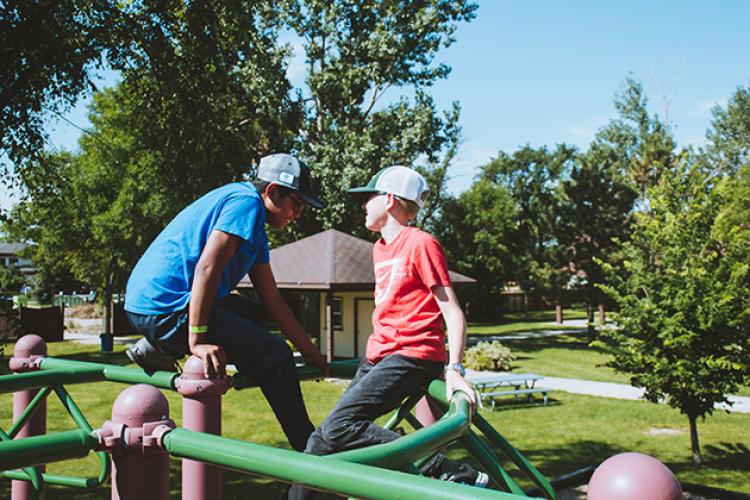 adaptivesummercamp3 This image shows two boys on the playground during the youth adaptive summer camp.