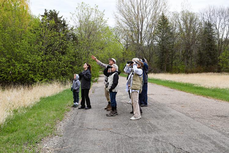 This image shows a group of people using binoculars during the birding program.