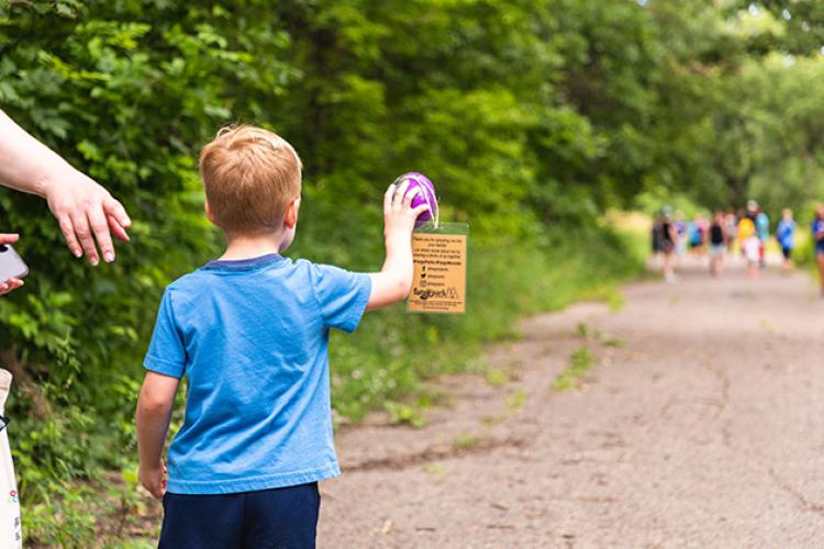 This image shows a boy finding an egg on the walk during Monstrous Imaginaton.