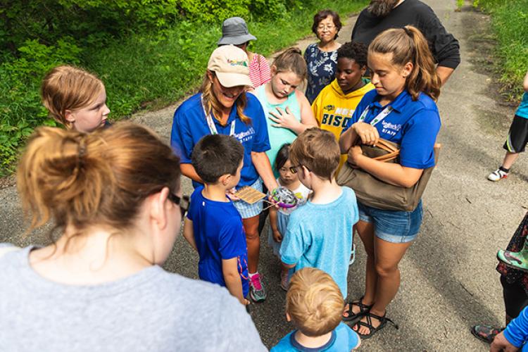 This image shows the instructor teaching kids about the egg they found on a walk during Monstrous Imagination.