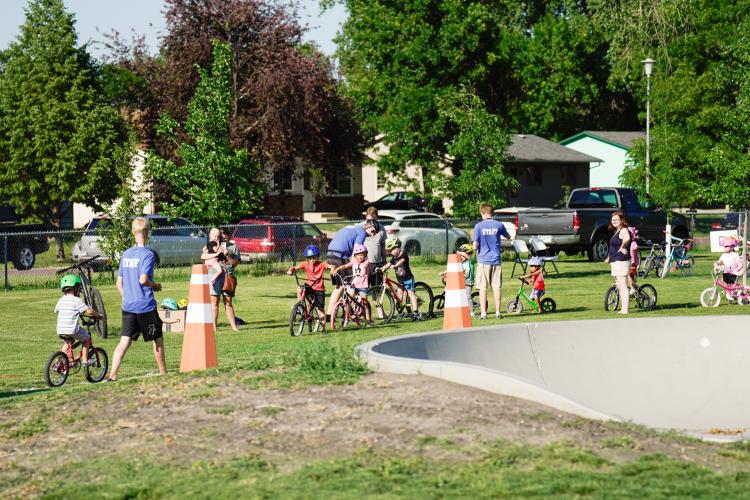 Many kids on bikes lined up at Madison Bike Park for kids triathlon bike event