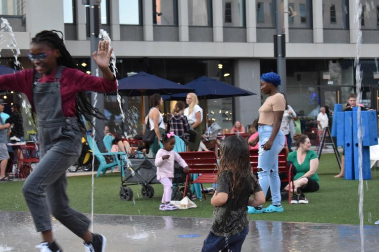 Photo of Kids in the Spouts at Broadway Square night bazaar