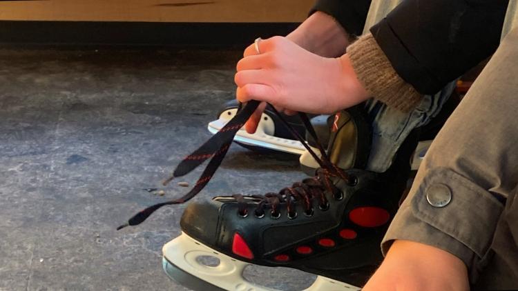 This image shows someone putting on their skates