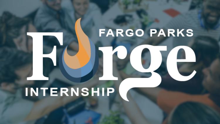 Forge Logo (Fargo Parks Forge Internship with a flame for the O in Forge) in white with a faded image of a group of young staff with their hands in about to break from a huddle over a desk