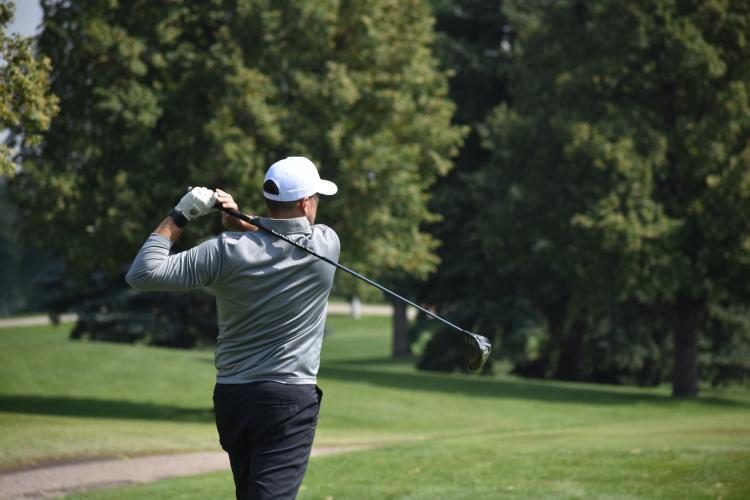 a man golfing on a golf course