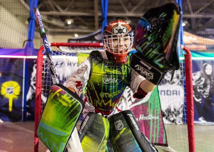 NHL STREET_ALLSTAR Child in goalie gear standing in front of goal for NHL Steet