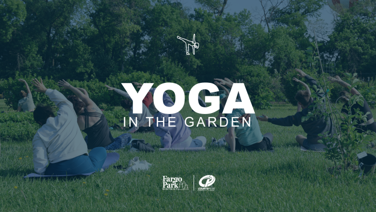 A group of people sitting on the grass in a yoga pose