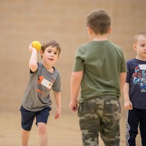 This image shows two boys playing catch at sports sampler.