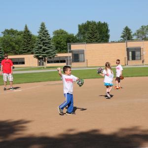 This image shows a kid playing t-ball. 