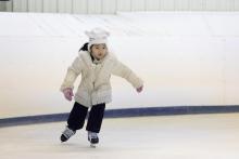 This image shows a young girl skating at Open Skate.