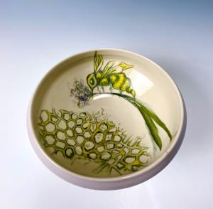 This image shows a hand painted ceramic bowl, painted by Annette Marchand.