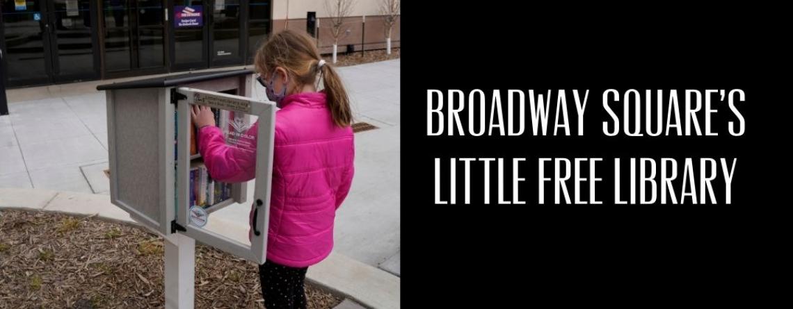 This image shows a girl choosing a book from the Little Free Library at Broadway Square.