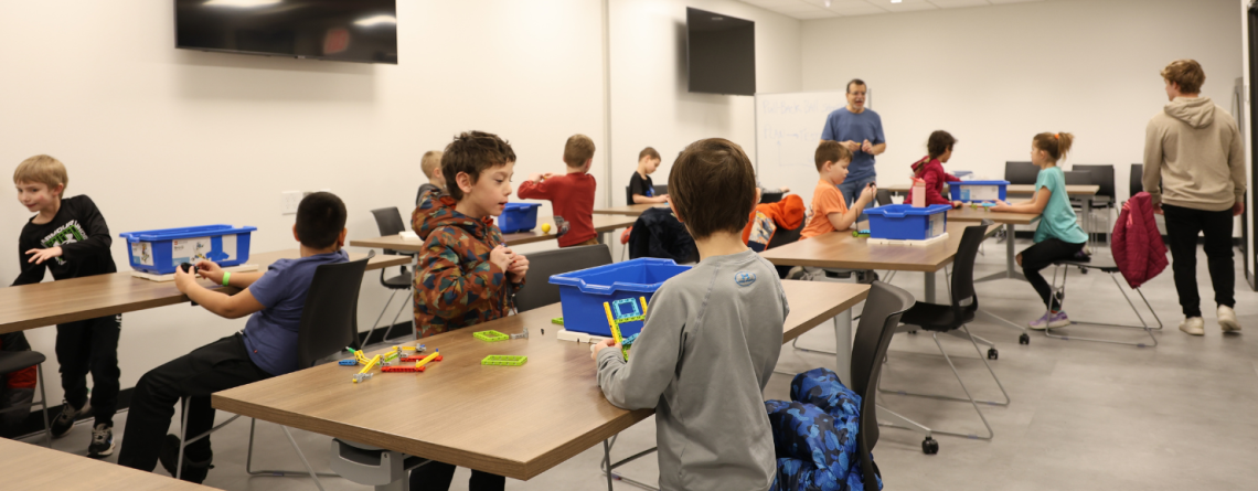 Children explore hands-on building and STEM activities during a community education class.