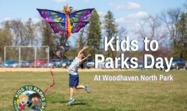 This image shows a young girl flying a kite during Kids to Parks Day.