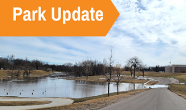 This image shows a graphic of Park Update atop a picture of a flooding park.