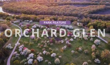 Picture of Orchard Glen Park in the spring with text in a purple box that says Park Feature Orchard Glen