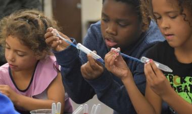 Photo of three children doing a science experiment