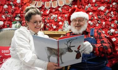 photo of santa and Mrs. Claus reading a book