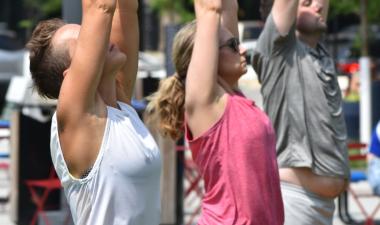 People doing yoga at Broadway Square