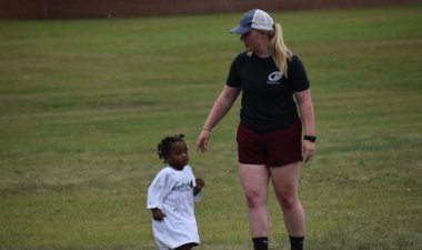 Photo of fargo parks employee teaching fitness to child.
