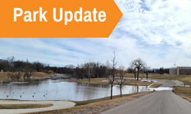This image shows a graphic of Park Update atop a picture of a flooding park.