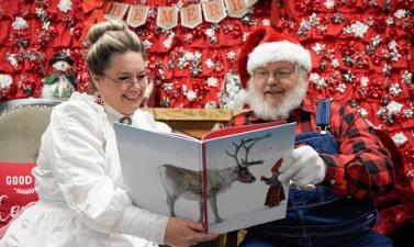 photo of santa and Mrs. Claus reading a book