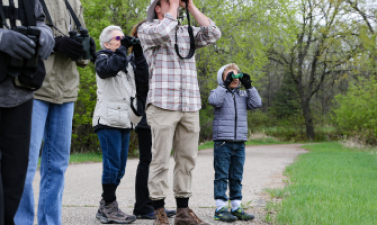 Photo of people looking through binoculars