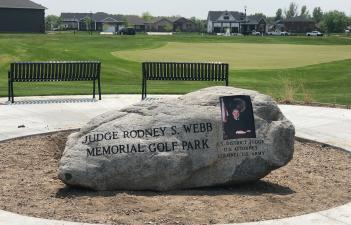This image shows the memorial rock at the Judge Rodney Webb Memorial Golf Park.