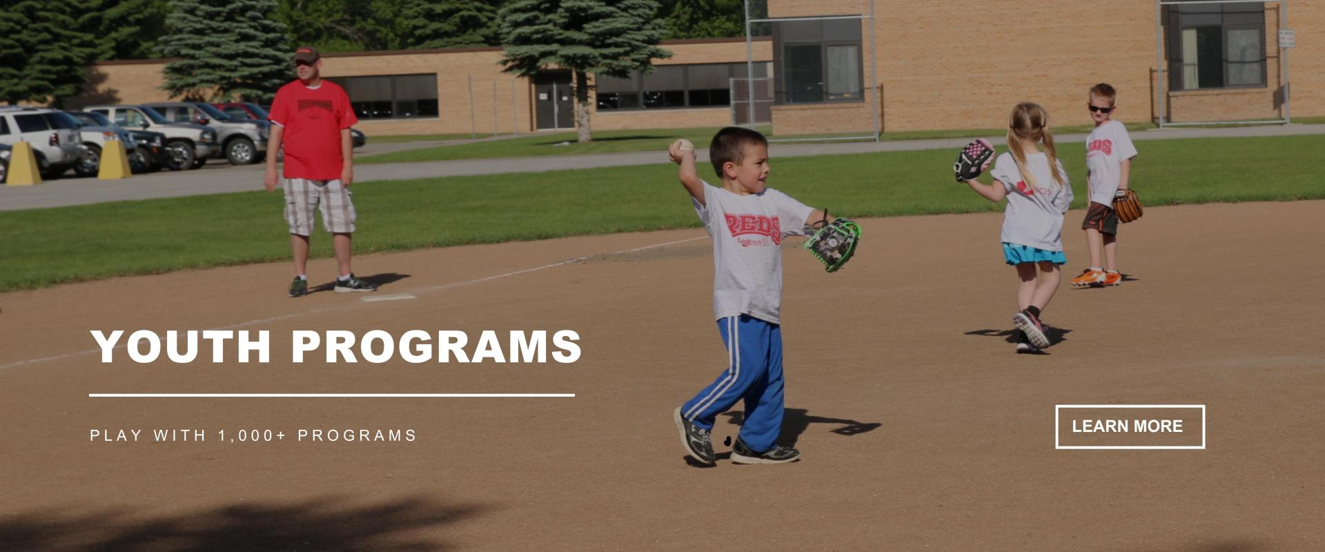 YOUTH PROGRAMS - Play with 1,000+ programs kids playing baseball on field with a coach