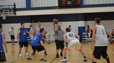 This image shows the tip-off at the adult basketball program.