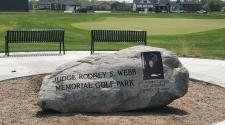 This image shows the memorial rock at the Judge Rodney Webb Memorial Golf Park.