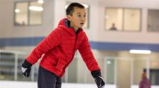 This image shows a boy ice skating.