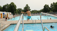 This image shows a boy diving into Island Park Pool.