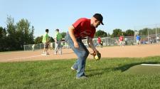 This image shows a male fielding the ball during the adaptive softball program.