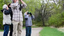 This image shows a young boy and the instructor looking into the sky during the birding program.