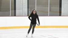 This image shows a girl skating at the ice skating program.