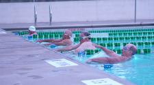 This image shows four men about to start a swim race at the North Dakota Senior Games.