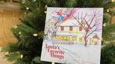 This image shows the book Santa's Favorite Things in the Christmas tree.