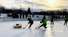 This image shows a player scoring at youth pond hockey.