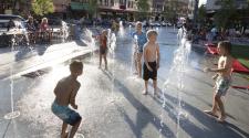 Young children playing at the interactive water fountains